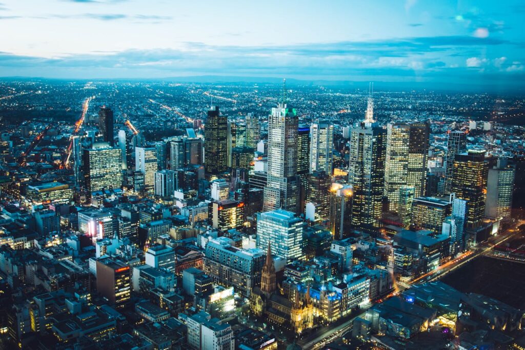 A breathtaking aerial view of Melbourne's illuminated skyline with modern skyscrapers at night.