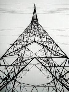 Perspective view of a high voltage transmission tower showcasing its intricate steel framework and power lines.