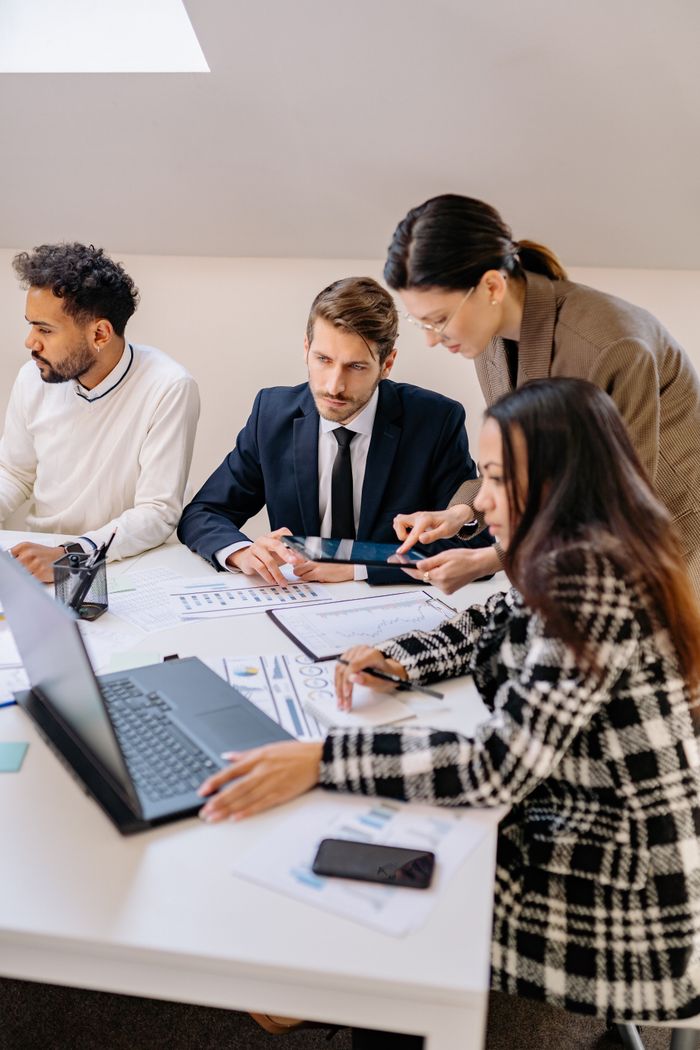 Home Professionals engaged in a meeting discussing plans in a modern office setting.